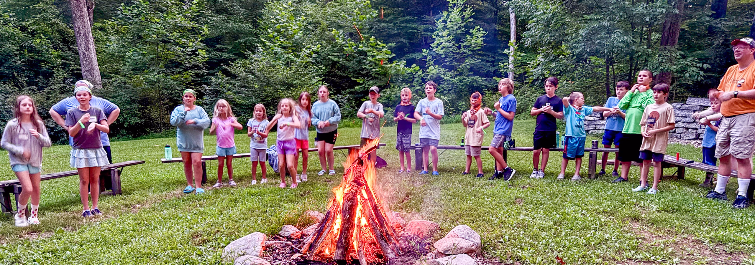 Camp kids around the campfire at Lutheran Outdoor Ministries: Indiana-Kentucky (LOMIK)